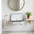Enameled steel bucket sink wall-mounted in a bright Scandinavian bathroom