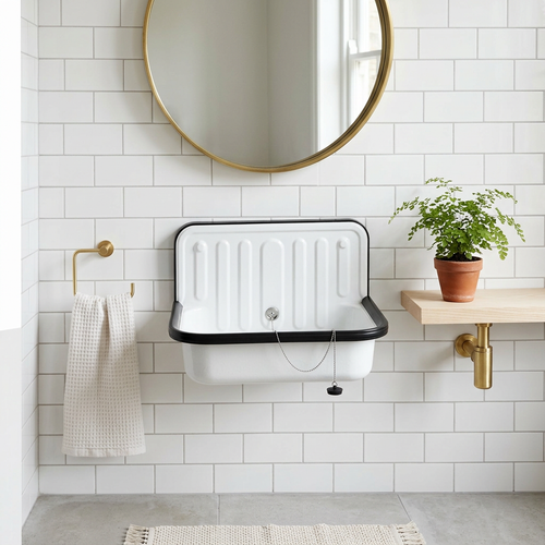Enameled steel bucket sink wall-mounted in a bright Scandinavian bathroom